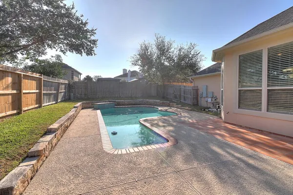 a view of a swimming pool with a patio