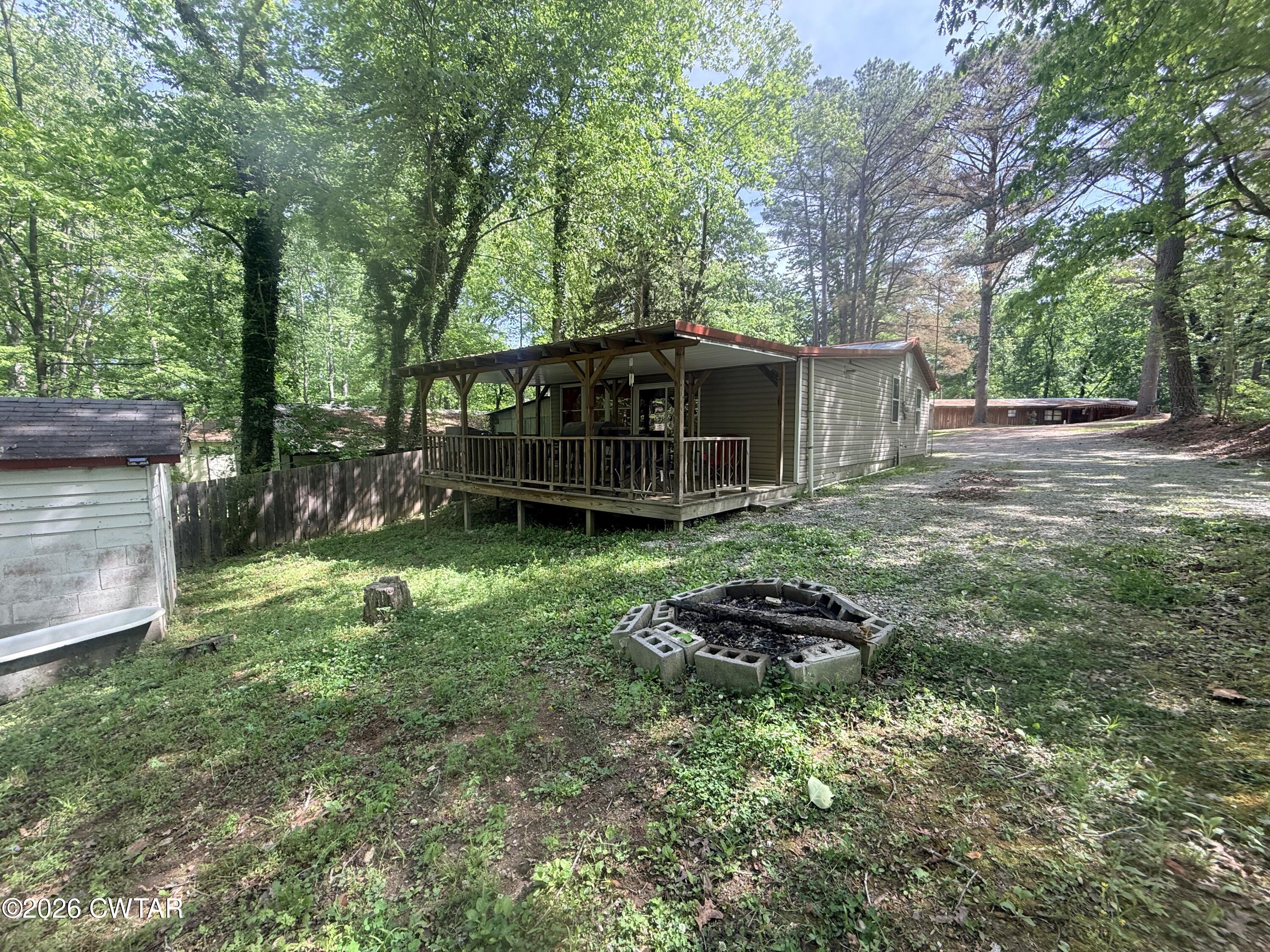 133 Maxine Nelson Road Parsons, TN 38363 - Photo 19 of 19 a backyard of a house with lots of green space