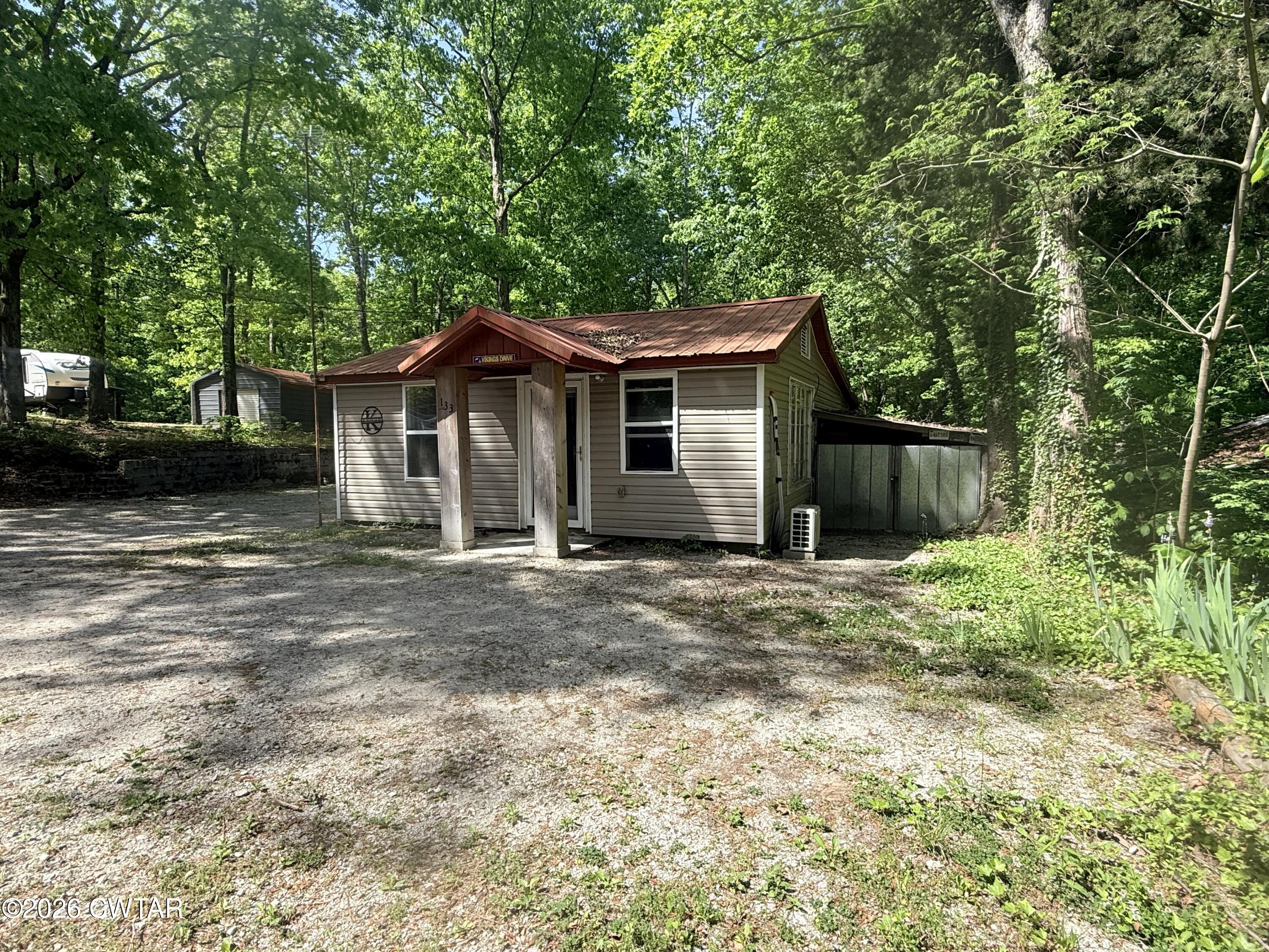 133 Maxine Nelson Road Parsons, TN 38363 - Photo 3 of 19 a front view of a house with a garden