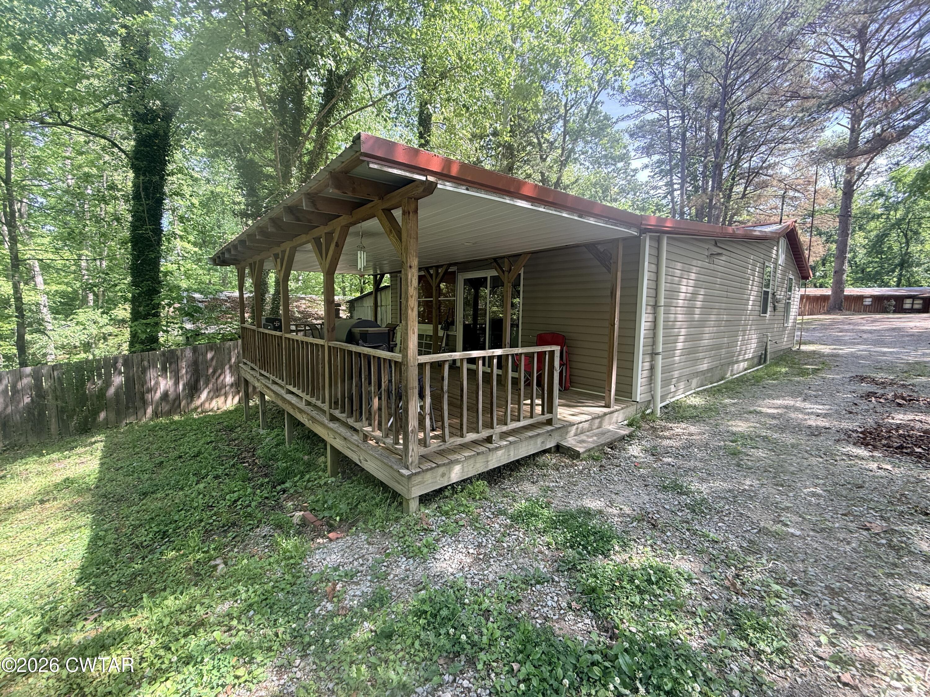 133 Maxine Nelson Road Parsons, TN 38363 - Photo 6 of 19 a view of a house with a yard and deck