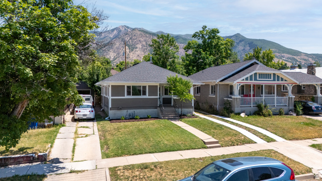 2862 Fowler Avenue Ogden, UT 84403 - Photo 19 of 23 Single-story residence featuring a gray exterior, dark shingle roof, and a mature tree providing shade