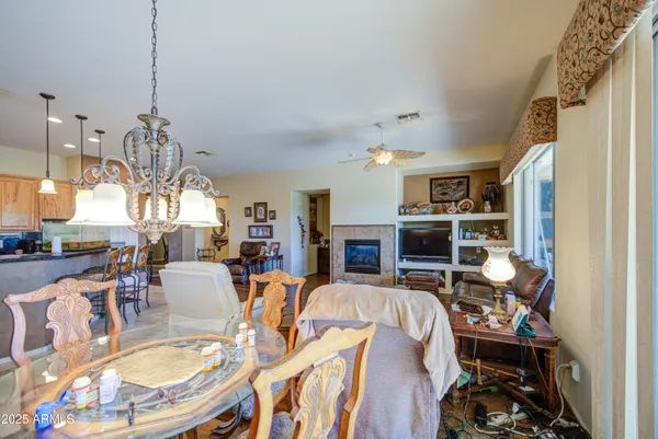 a living room with furniture a flat screen tv and a floor to ceiling window