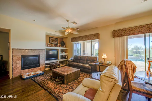 a living room with furniture a flat screen tv and a fireplace