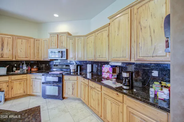 a kitchen with stainless steel appliances a refrigerator sink and cabinets