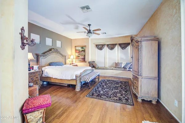 a bedroom with a bed dresser and a window