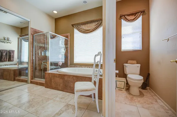 a large en suite bathroom with a tub sink and mirror