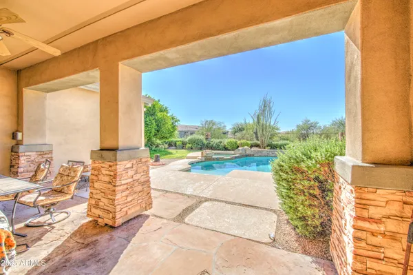 a view of a house with pool and chairs