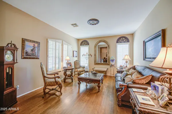 a living room with furniture and a lamp