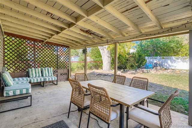 a view of a patio with a table and chairs