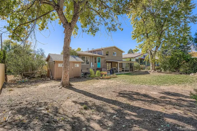 a front view of a house with a yard and trees
