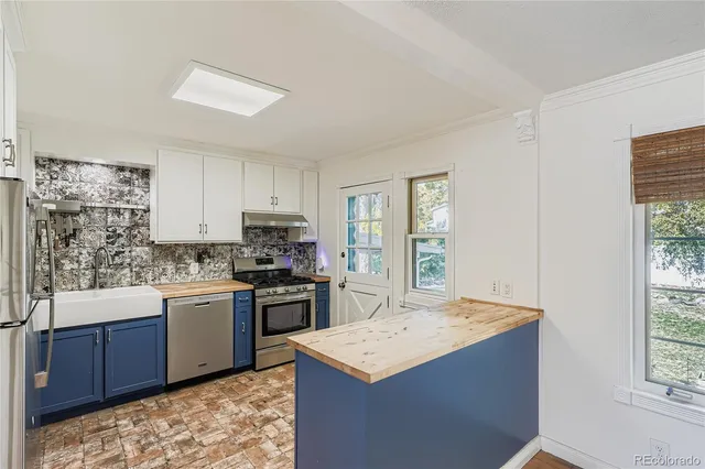 a kitchen with a sink stove and refrigerator