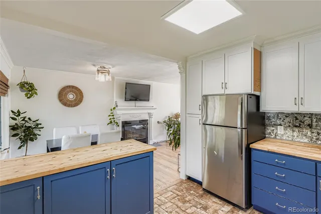 a kitchen with a refrigerator and a sink