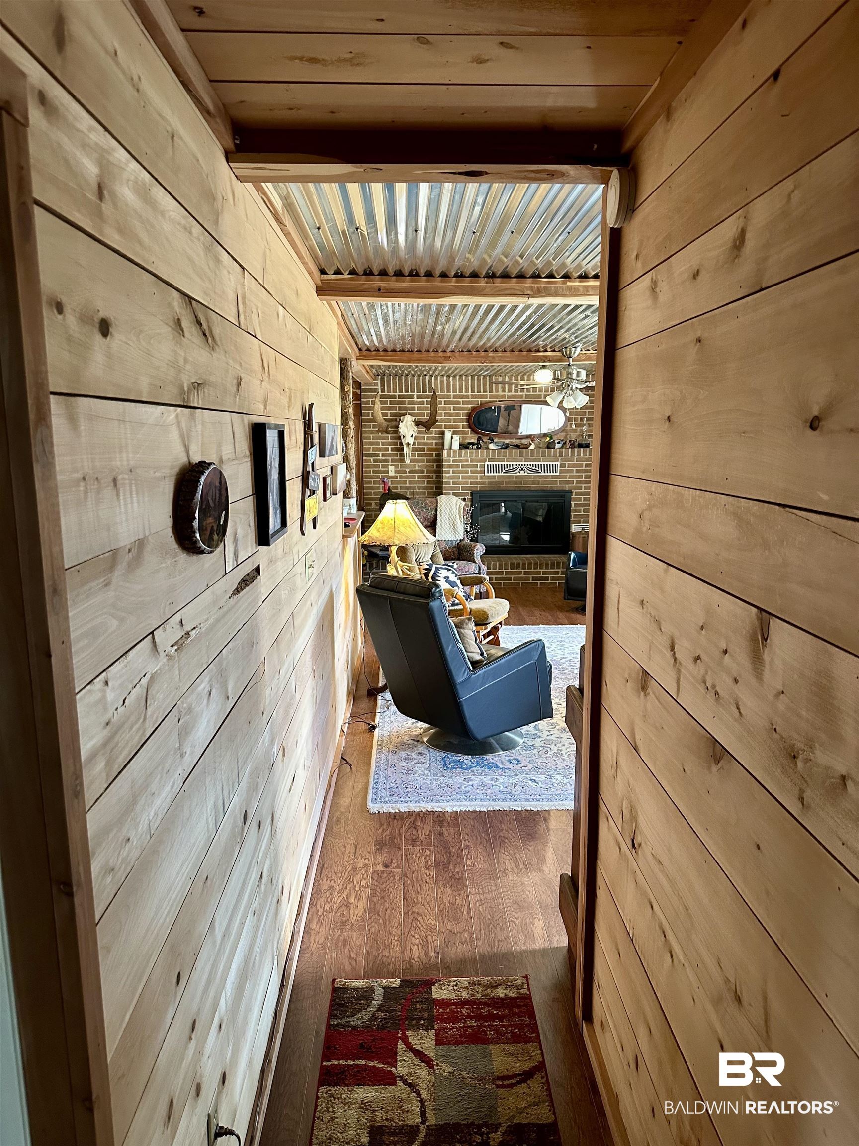 2772 Ramah Road Evergreen, AL 36401 - Photo 4 of 12 Corridor featuring beam ceiling, wooden walls, wood ceiling, and wood finished floors