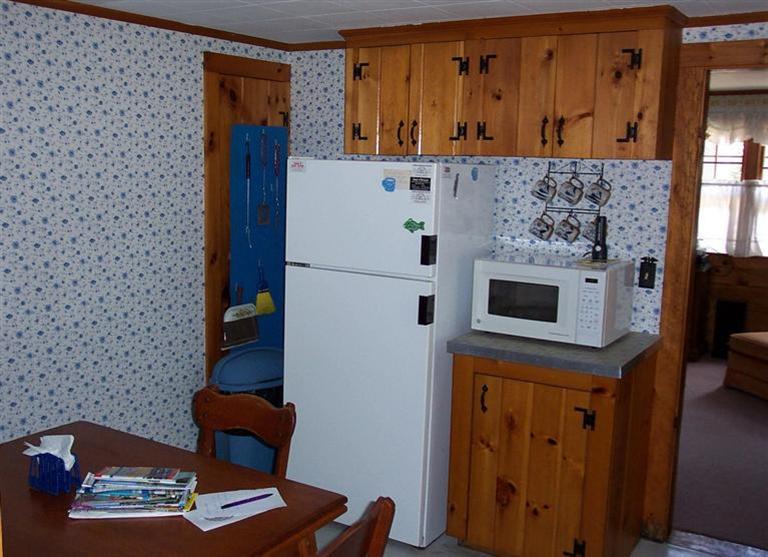 55 Captain Chase Road Dennis Port, MA 02639 - Photo 16 of 18 a white refrigerator freezer sitting in a kitchen