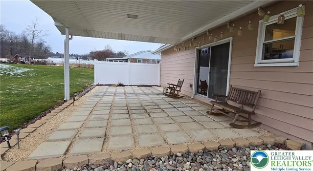 a view of a backyard with sitting area