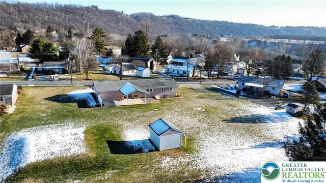 a swimming pool with outdoor seating and mountain view