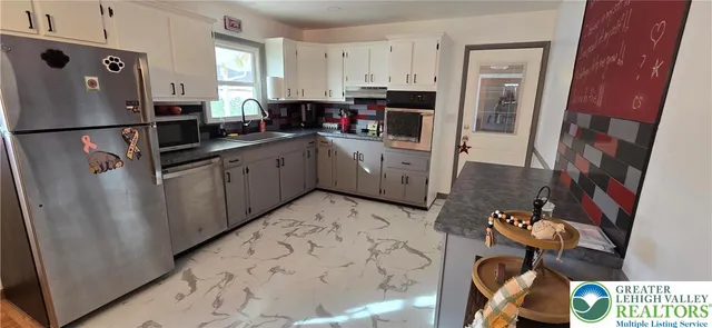 a kitchen with a sink cabinets and refrigerator