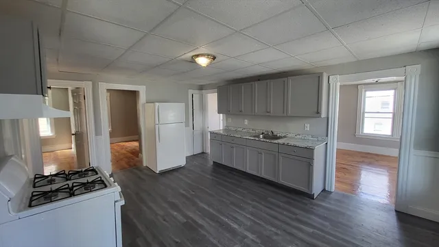 a kitchen with a refrigerator and a stove top oven