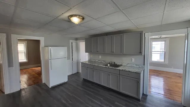 a kitchen with a sink and wooden cabinets