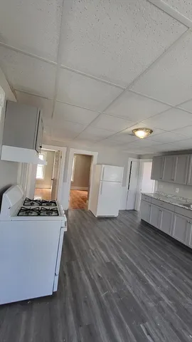 a kitchen with a stove and white cabinets