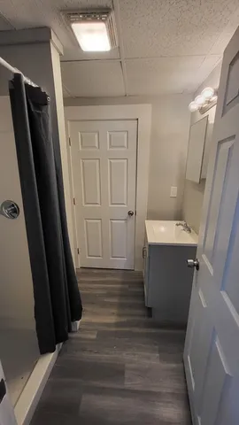 a bathroom with a shower and a mirror