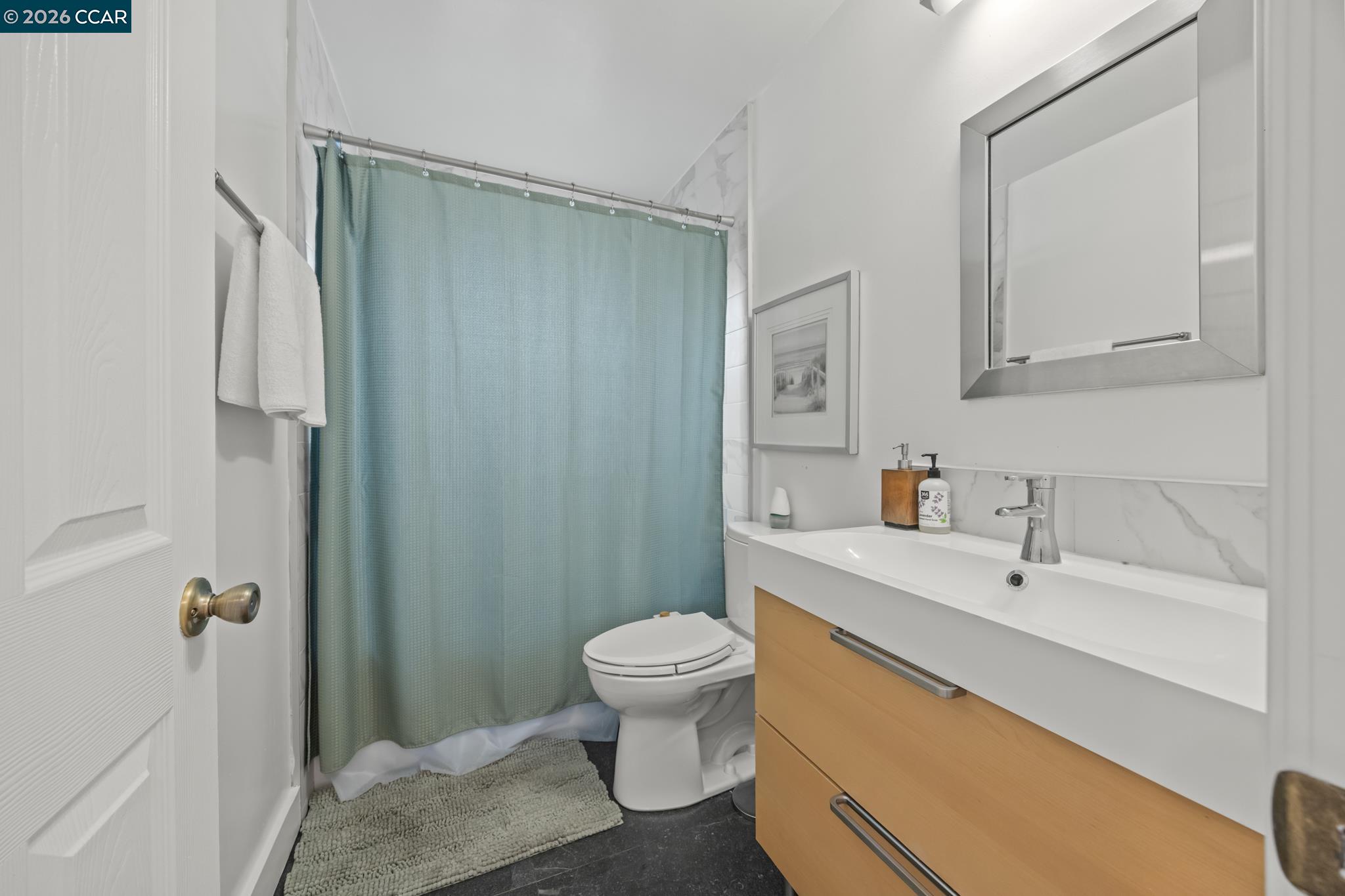 2327 Tenth Street, Unit 4 Berkeley, CA 94710 - Photo 24 of 39 a bathroom with a sink toilet and shower