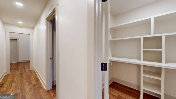a view of hallway with stairs and wooden floor
