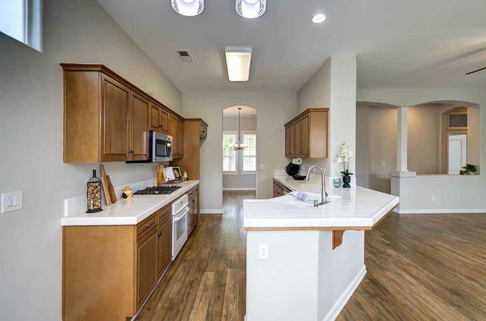3235 Rall Avenue Clovis, CA 93619 - Photo 12 of 33 a kitchen with a sink stove and cabinets