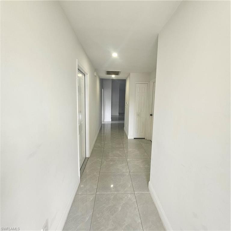 4722 29th Street Southwest Lehigh Acres, FL 33973 - Photo 2 of 12 Hall featuring baseboards and recessed lighting
