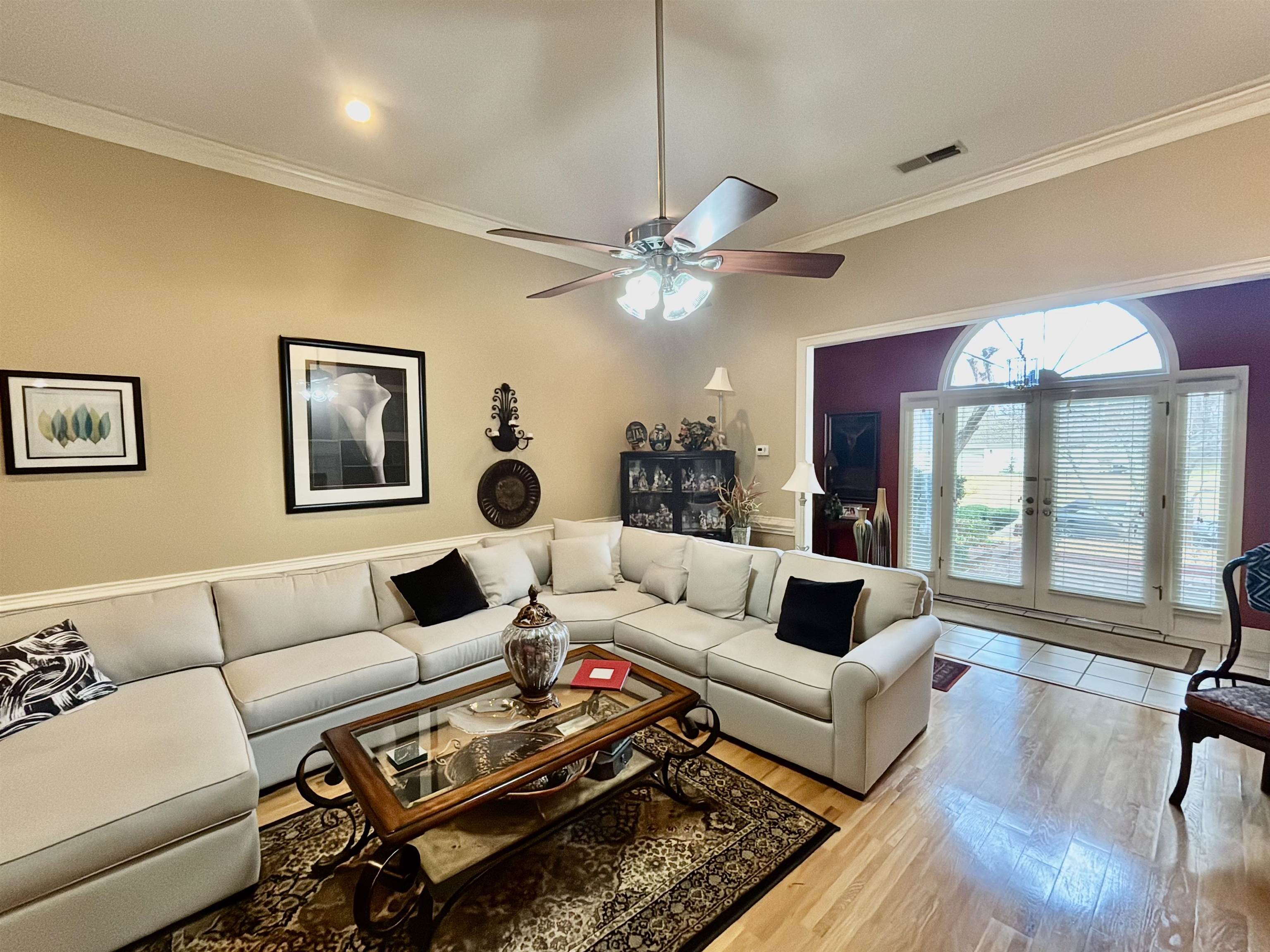 Living room featuring ceiling fan, ornamental molding, french doors, and light hardwood / wood-style flooring