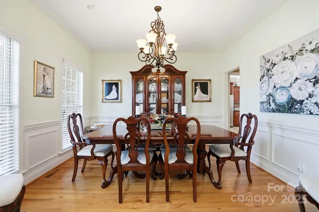 a view of a dining room with furniture and chandelier