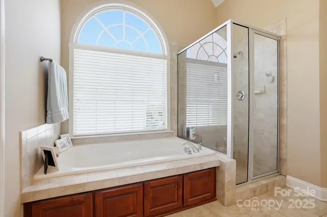 a bathroom with a tub sink and a mirror