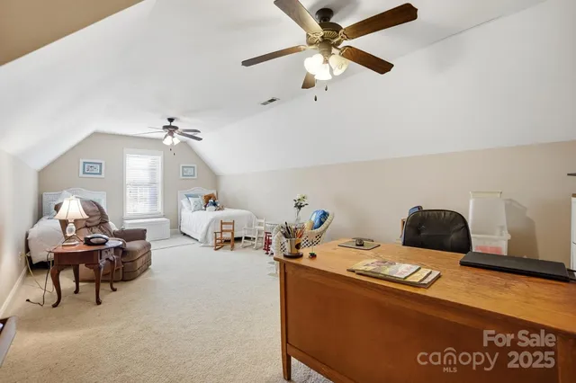 a bedroom with furniture and a chandelier