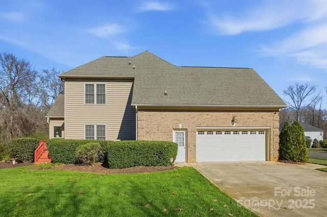 a view of a house with a yard and garage