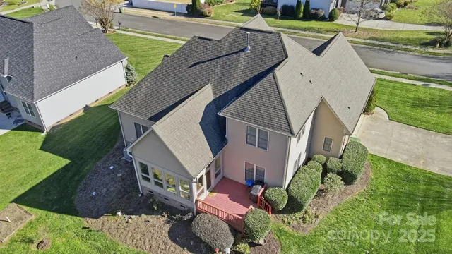 an aerial view of a house with outdoor space and a patio