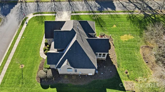 an aerial view of a house with swimming pool garden and patio
