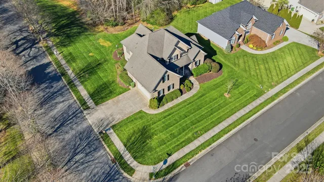 an aerial view of a house with garden space and trees