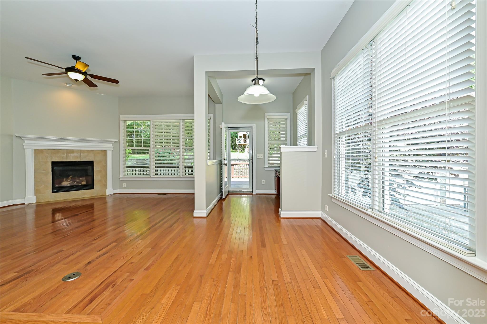 105 Mills Lane Fort Mill, SC 29708 - Photo 14 of 41 a view of an empty room with wooden floor fireplace and a window