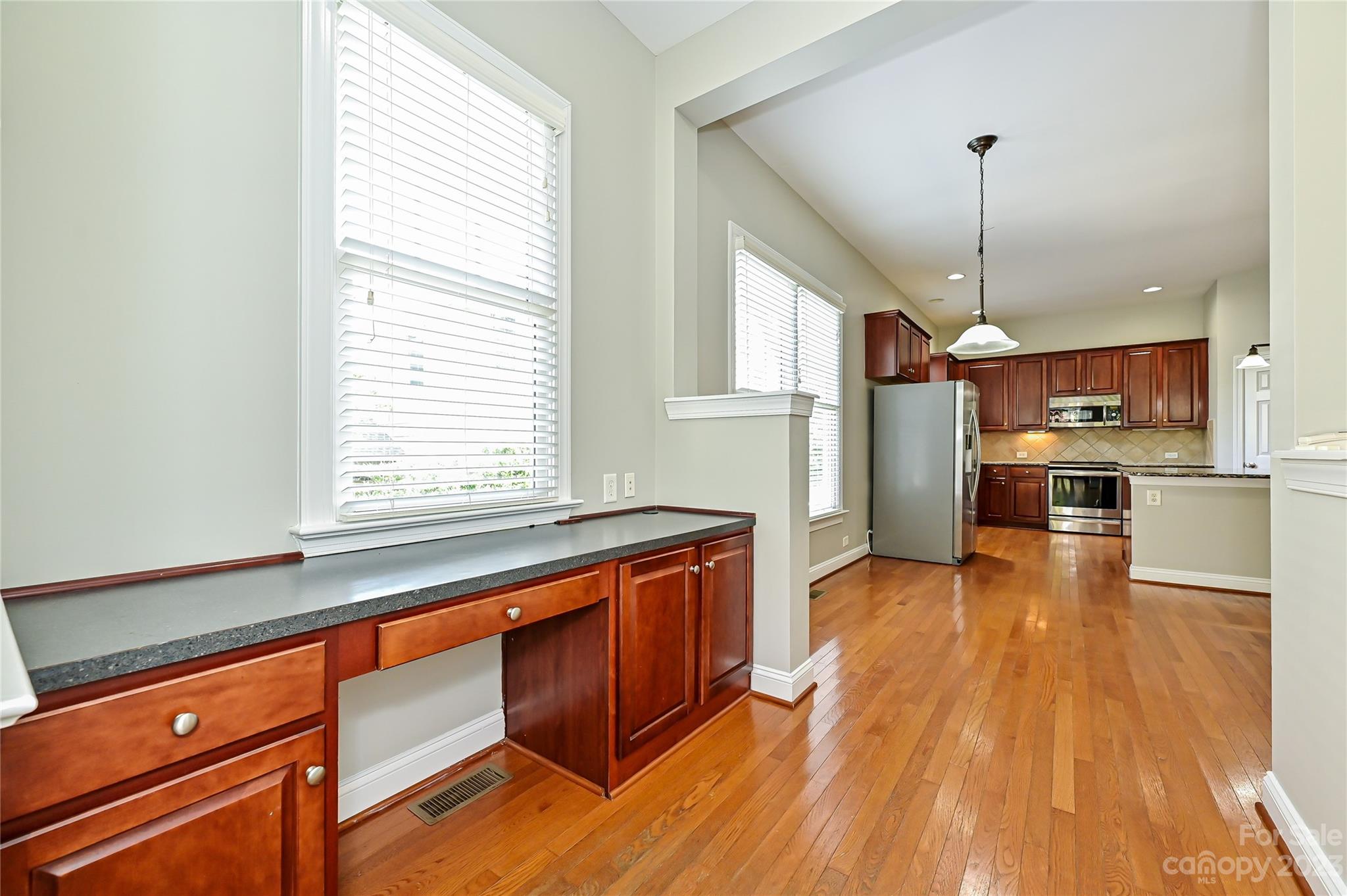 105 Mills Lane Fort Mill, SC 29708 - Photo 16 of 41 a kitchen with stainless steel appliances granite countertop wooden floors and sink