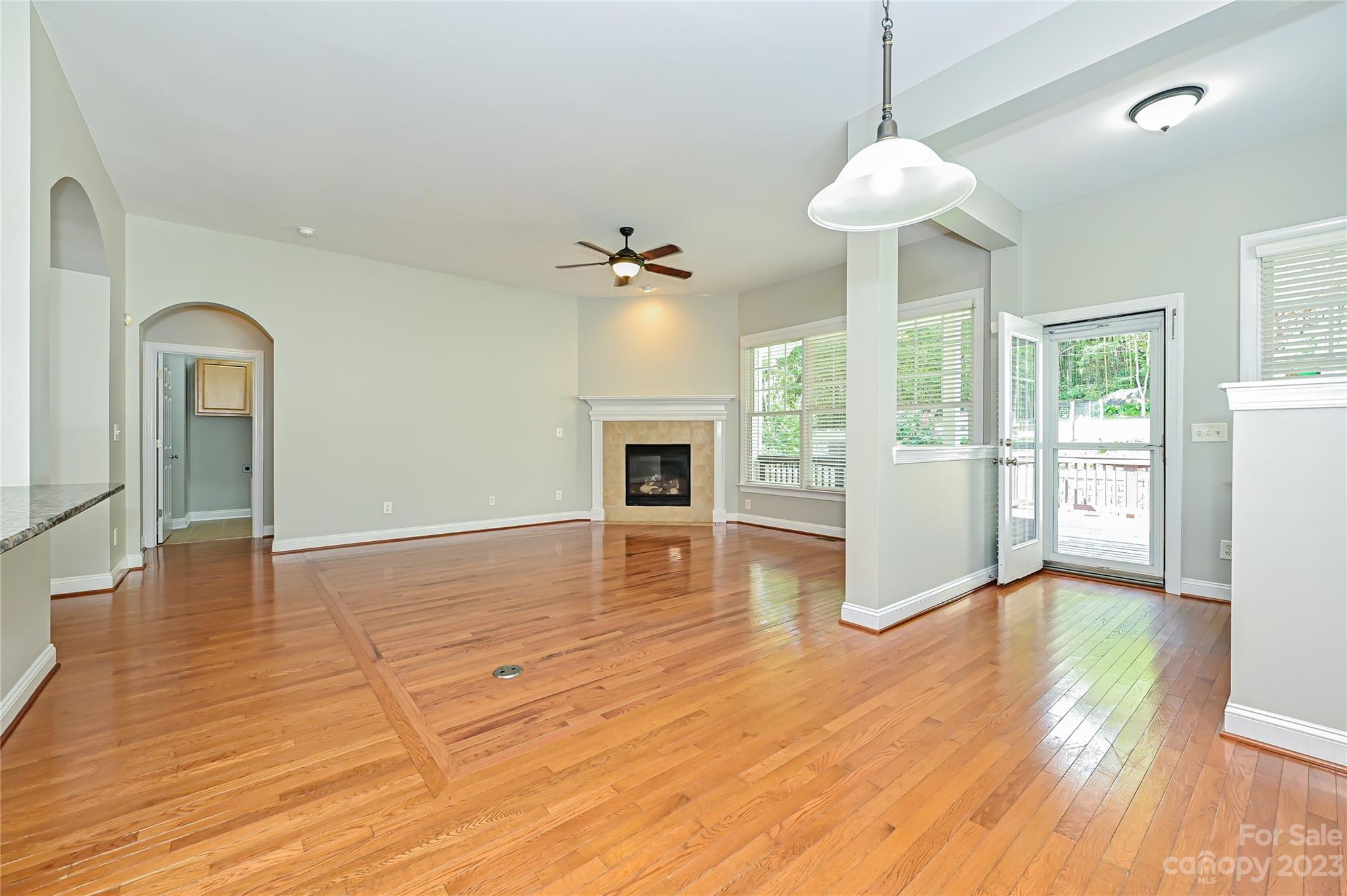 105 Mills Lane Fort Mill, SC 29708 - Photo 18 of 41 a view of an empty room with wooden floor and a fireplace