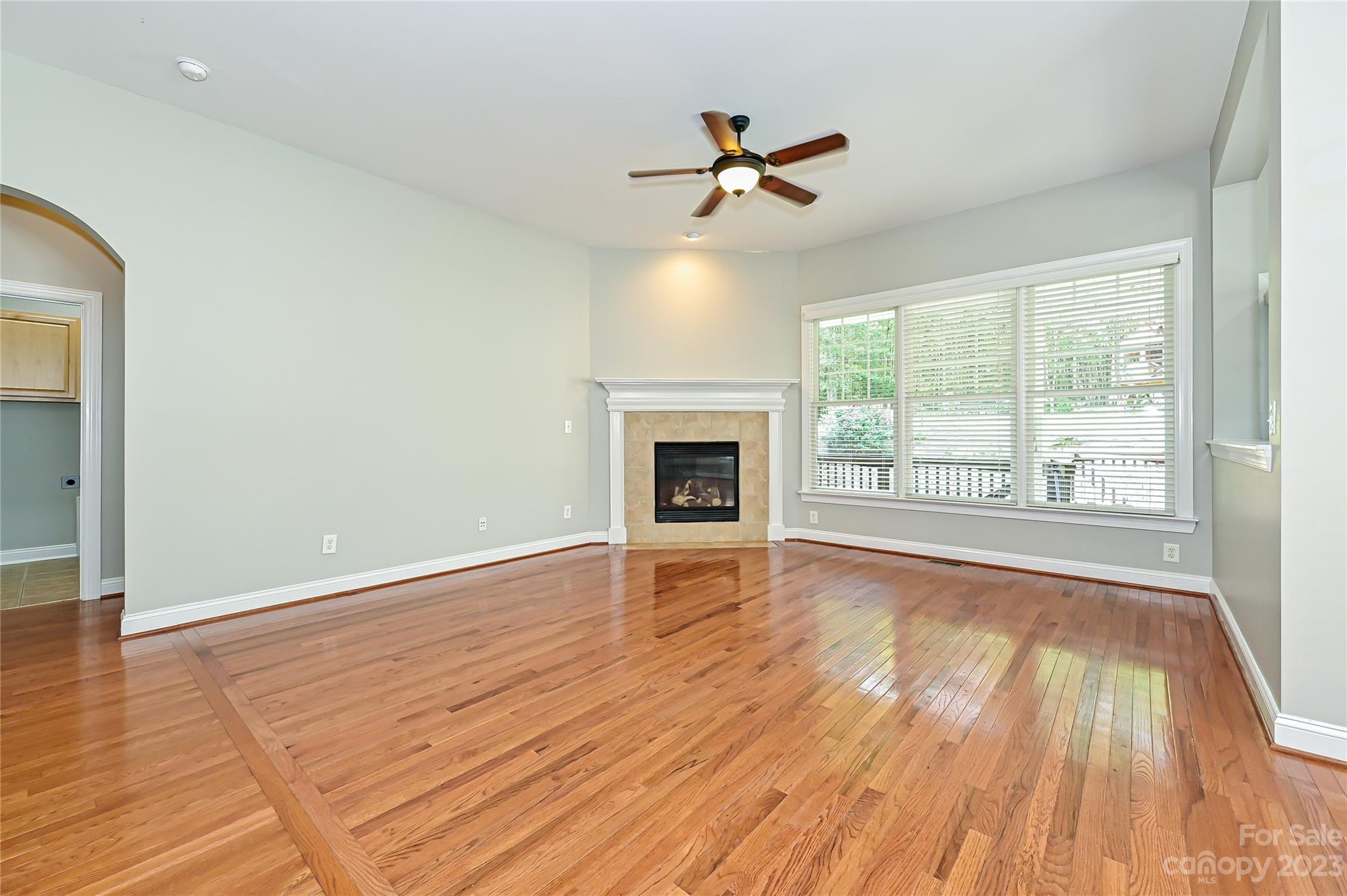 105 Mills Lane Fort Mill, SC 29708 - Photo 19 of 41 a view of empty room with wooden floor and fan