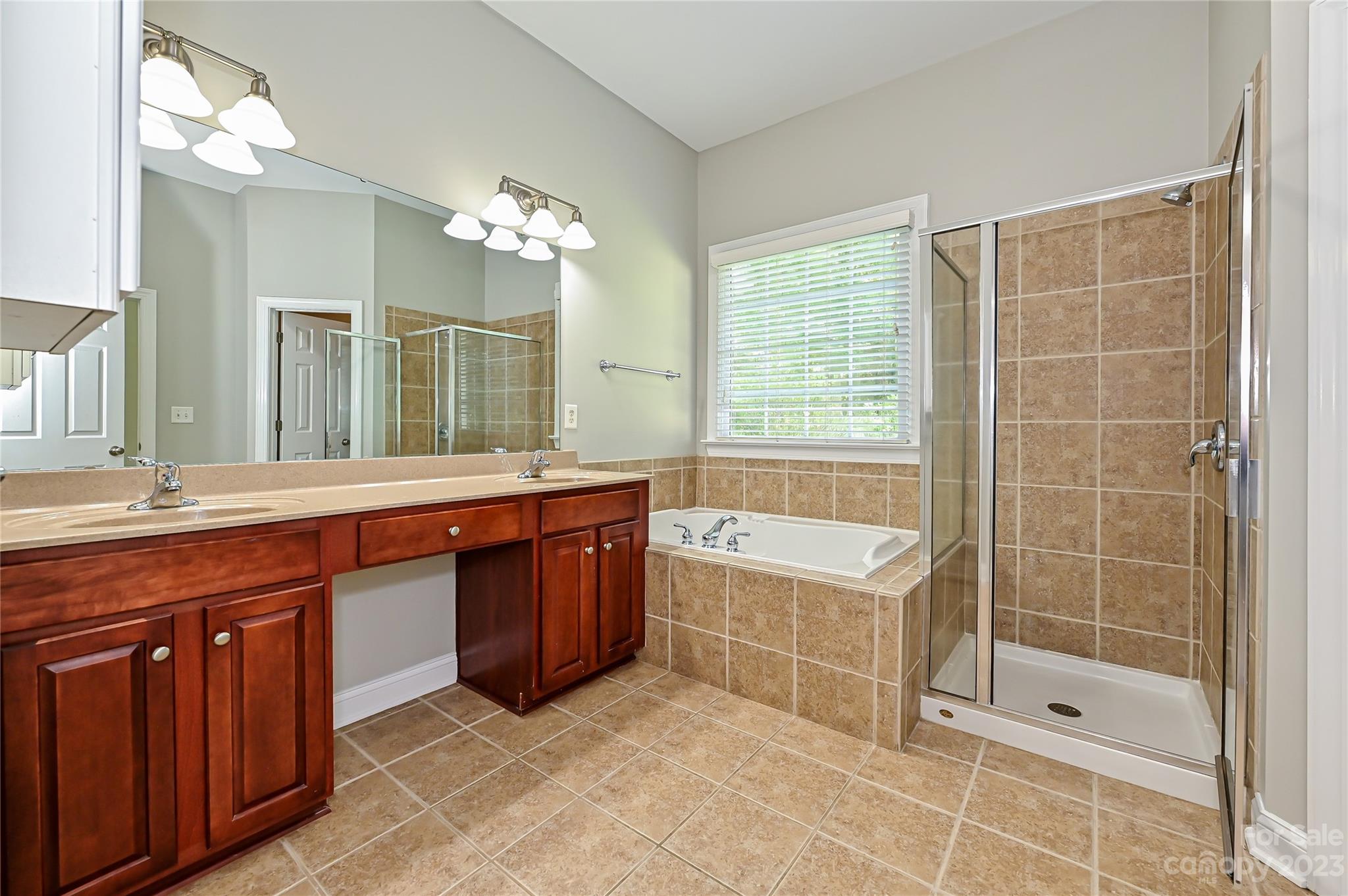 105 Mills Lane Fort Mill, SC 29708 - Photo 21 of 41 a spacious bathroom with a tub sink shower and mirror