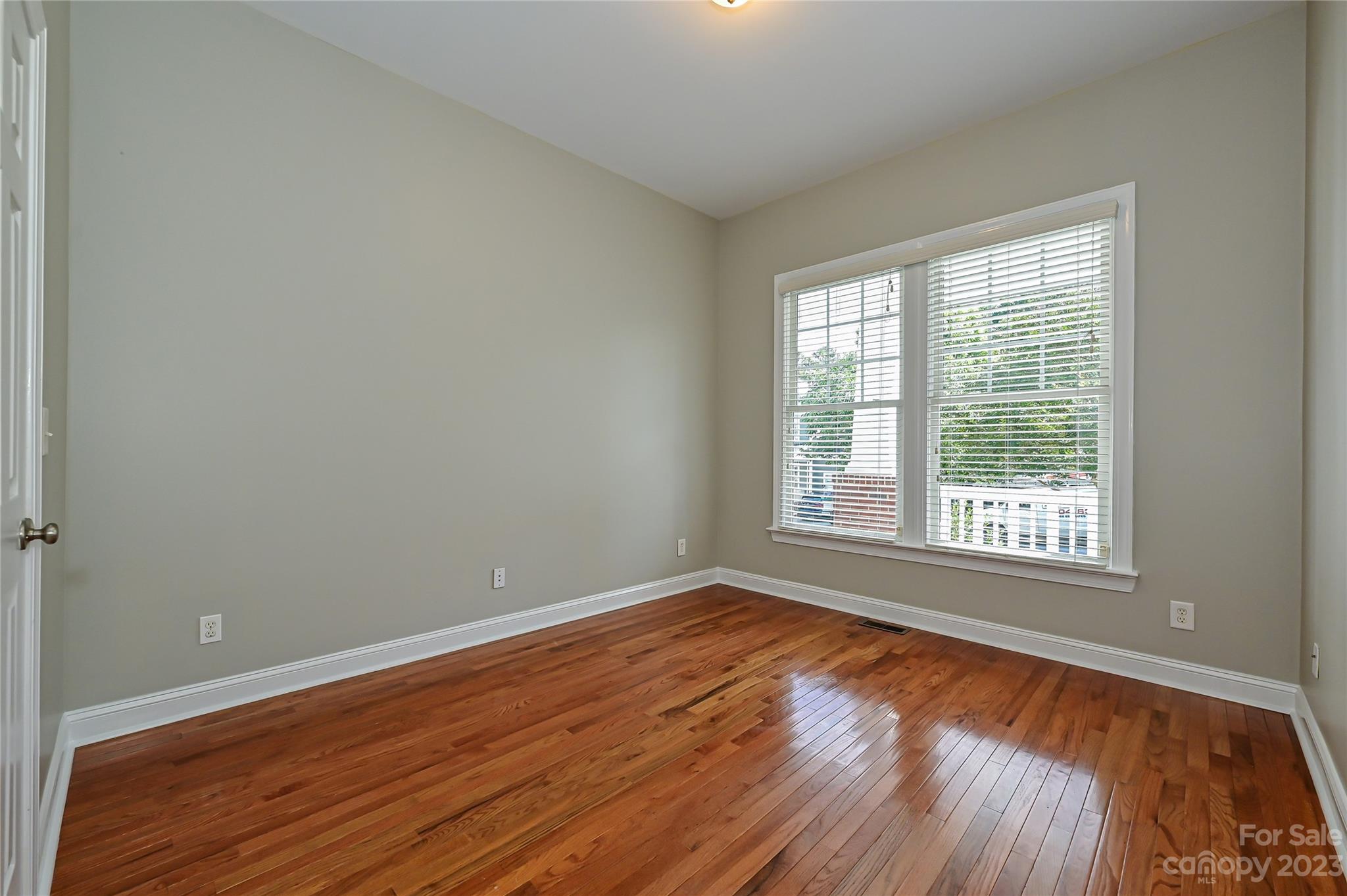 105 Mills Lane Fort Mill, SC 29708 - Photo 24 of 41 a view of an empty room with wooden floor and a window
