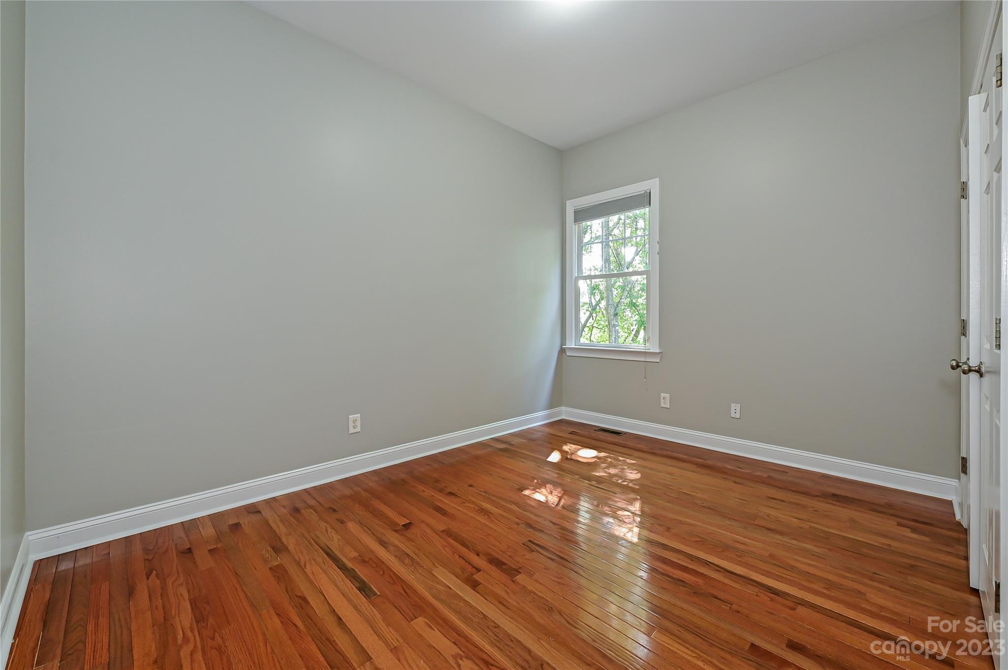 105 Mills Lane Fort Mill, SC 29708 - Photo 28 of 41 a view of an empty room with wooden floor and a window