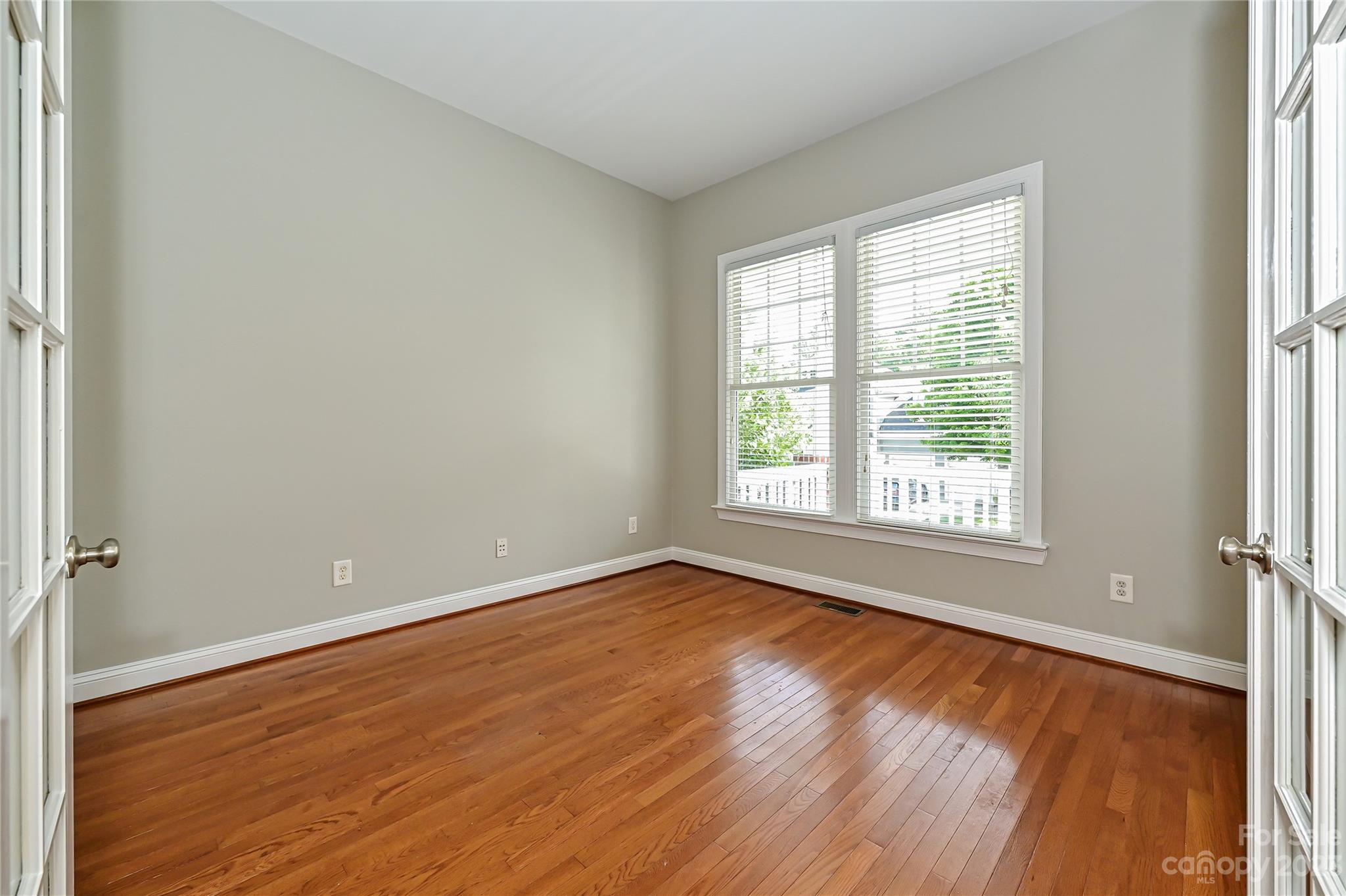 105 Mills Lane Fort Mill, SC 29708 - Photo 5 of 41 an empty room with wooden floor and windows