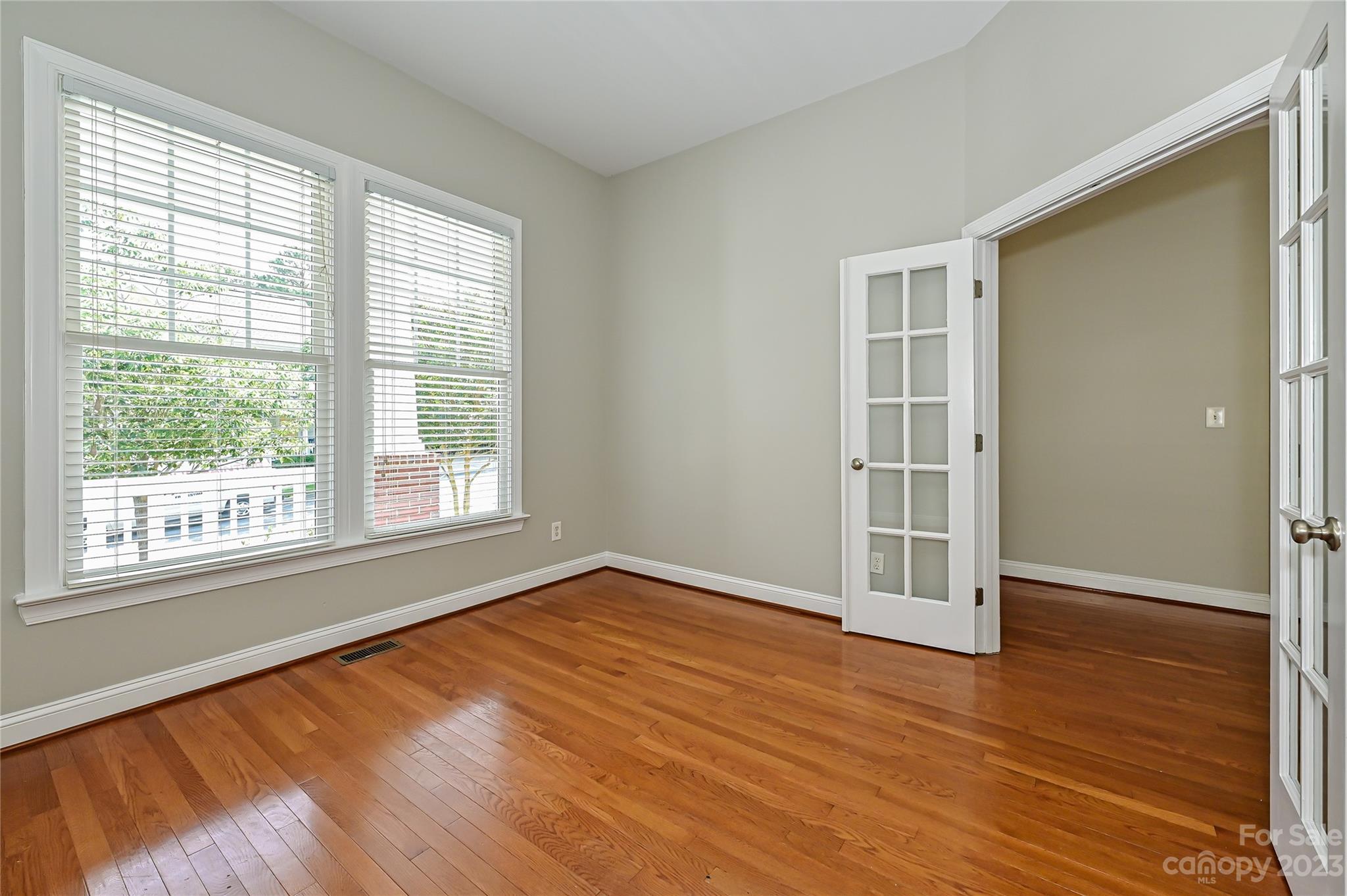 105 Mills Lane Fort Mill, SC 29708 - Photo 6 of 41 an empty room with wooden floor and windows