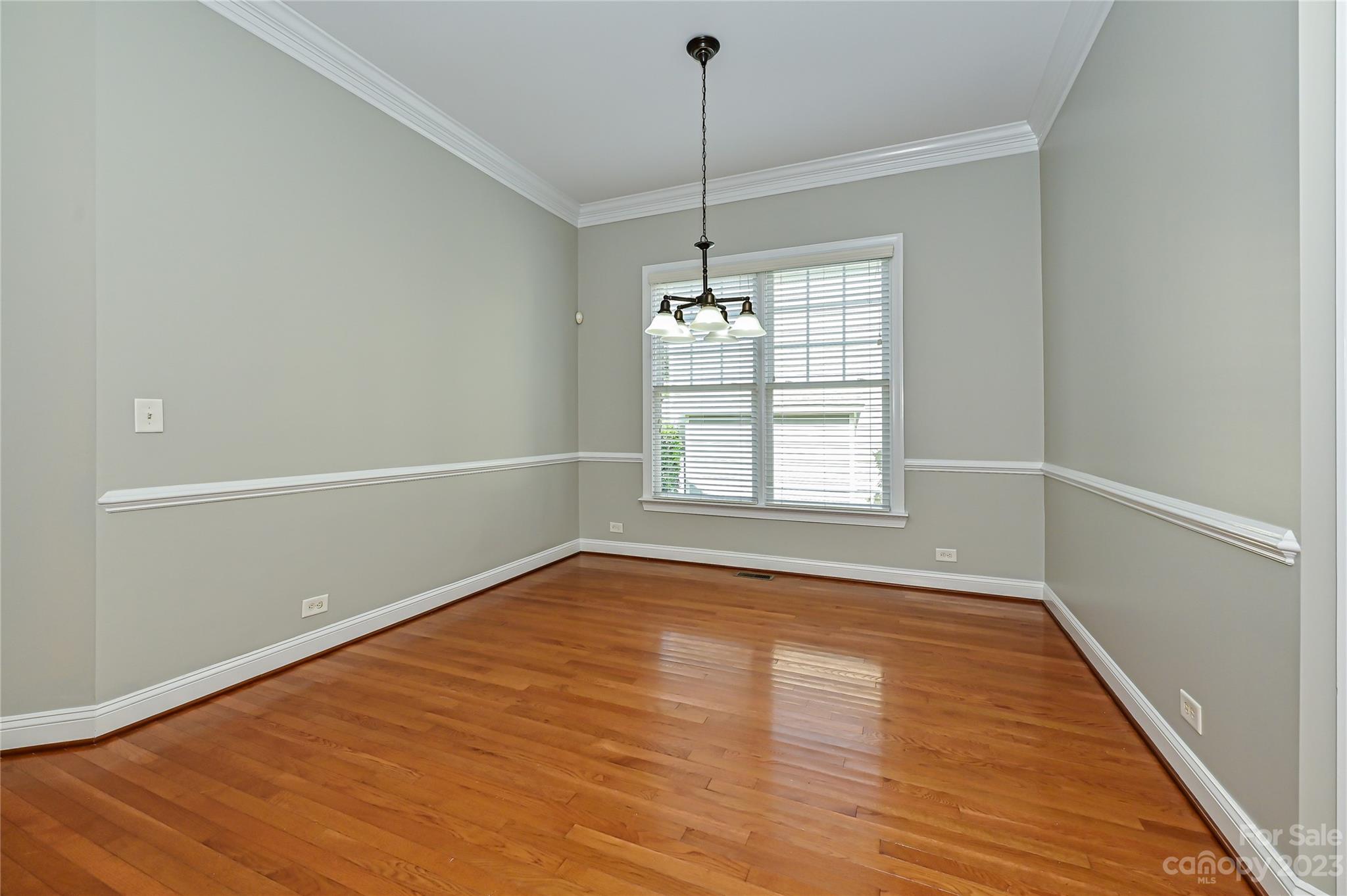 105 Mills Lane Fort Mill, SC 29708 - Photo 7 of 41 a view of an empty room with wooden floor and a window