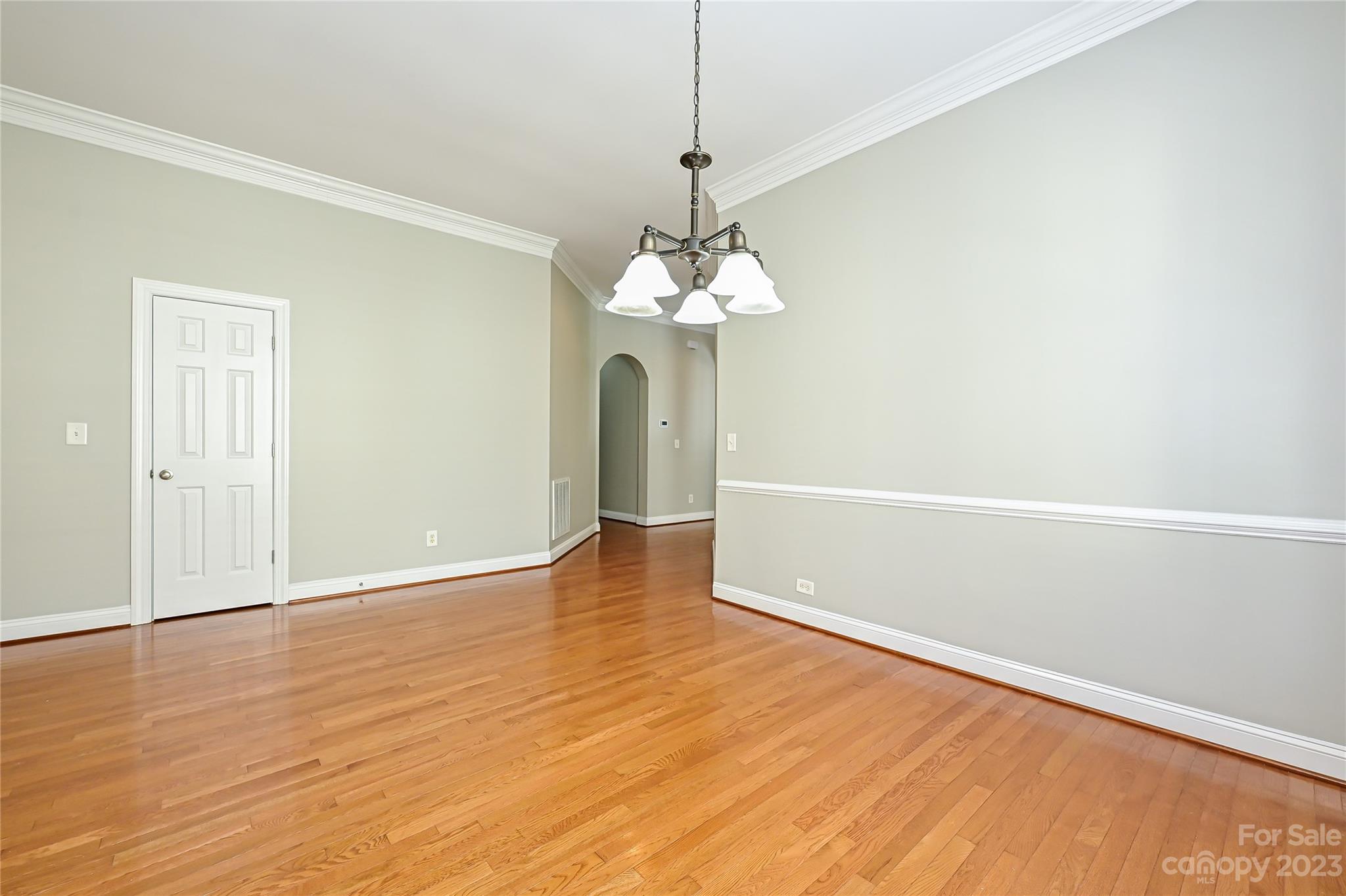 105 Mills Lane Fort Mill, SC 29708 - Photo 8 of 41 a view of a room with wooden floor and chandelier