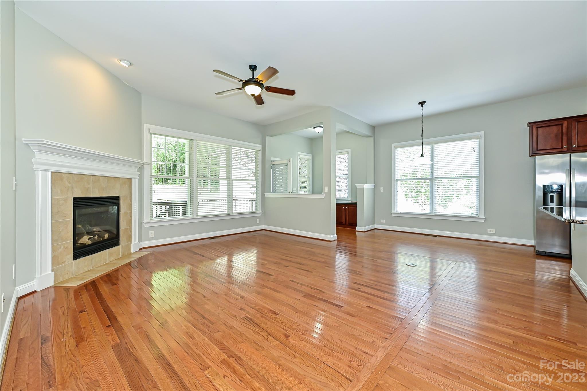 105 Mills Lane Fort Mill, SC 29708 - Photo 9 of 41 a view of an empty room with wooden floor and a window