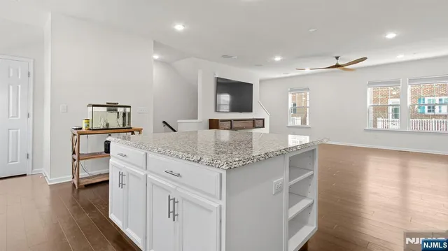 an open kitchen with white cabinets and stainless steel appliances
